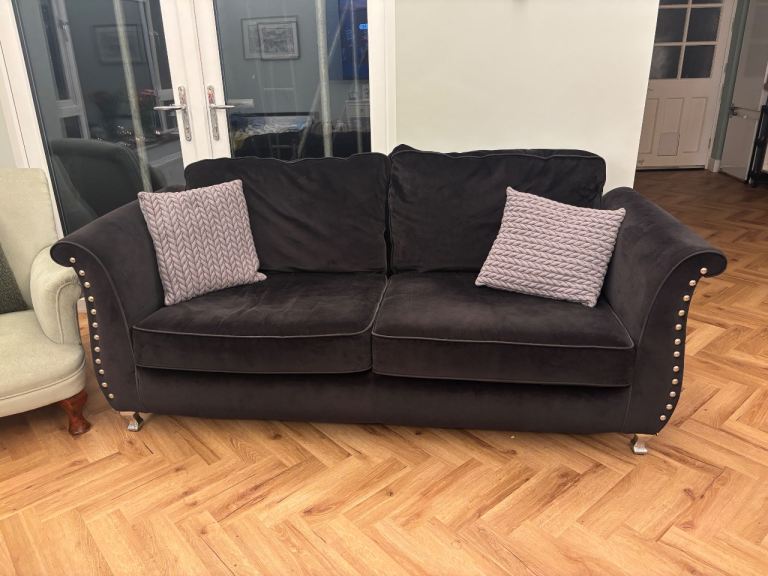 Large black sofa and footstool