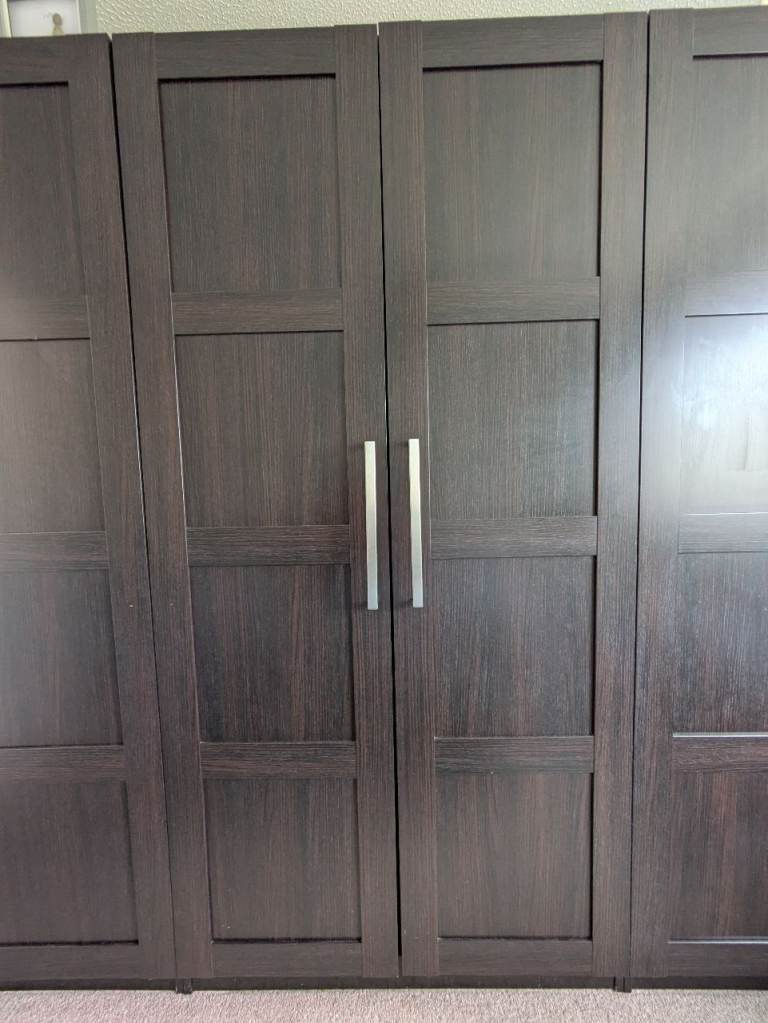 IKEA pax wardrobe with wire baskets. Dark brown