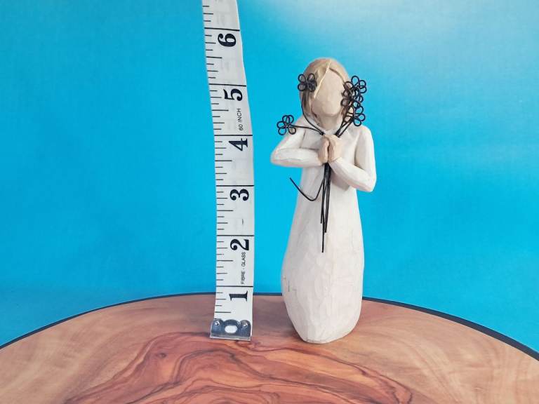 This is a "Friendship" figurine from the Willow Tree collection, designed by artist Susan Lordi.. 