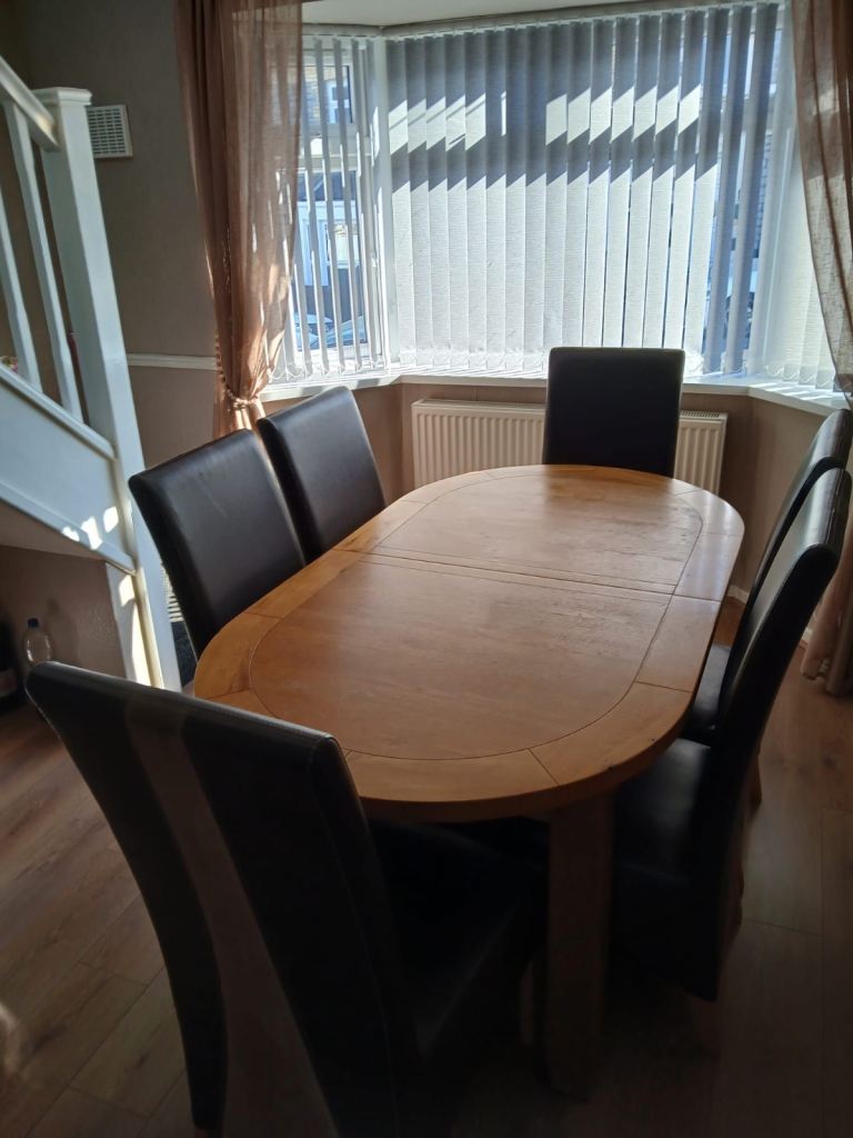 Sold oak oval table and 6 leather chairs 