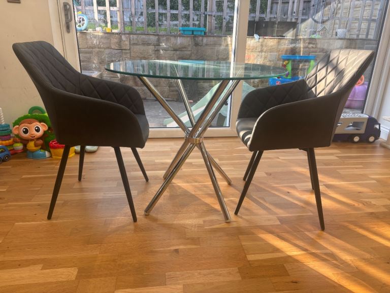 Glass dining table and 2 swivel grey chairs brand new